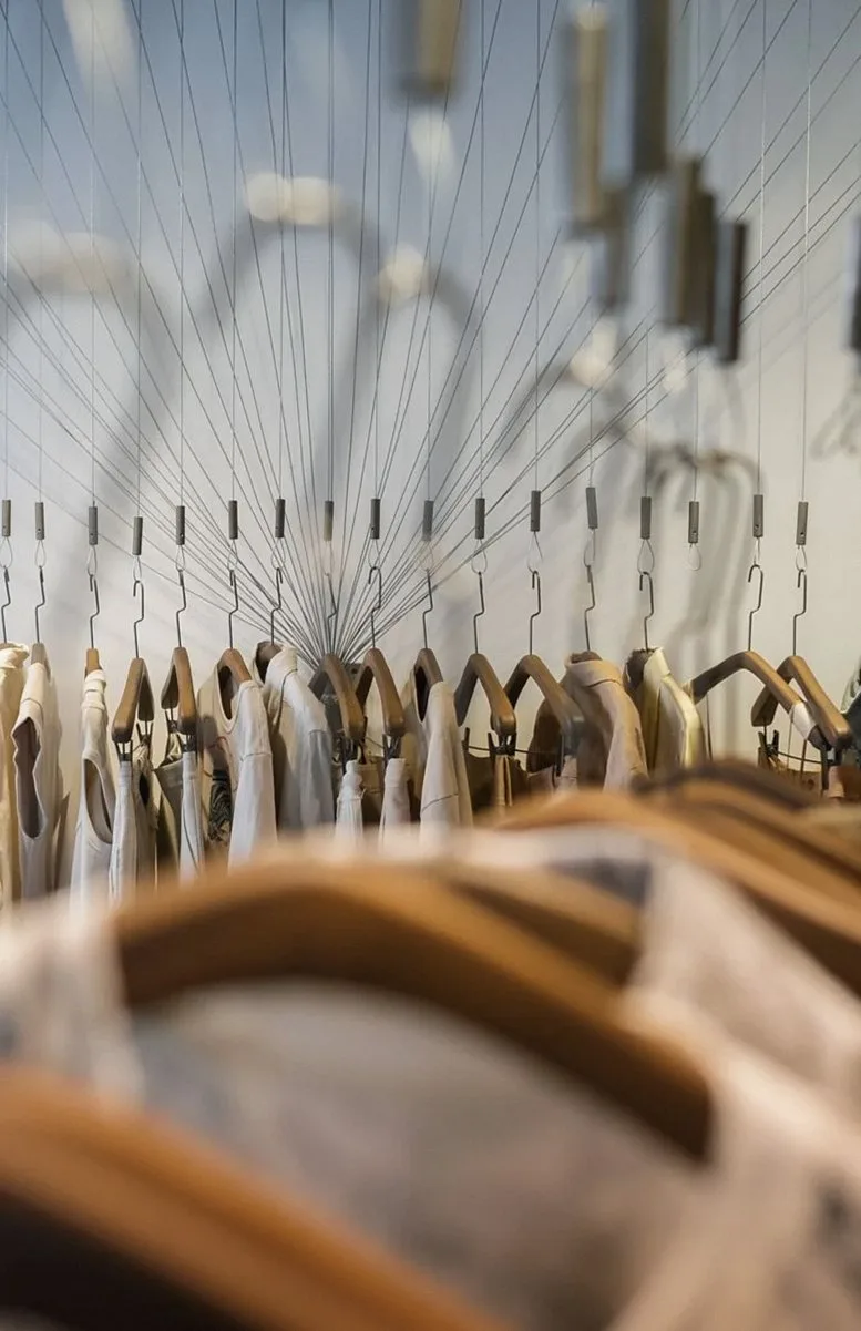 A stylish arrangement of clothes on hangers in a chic fashion boutique.
